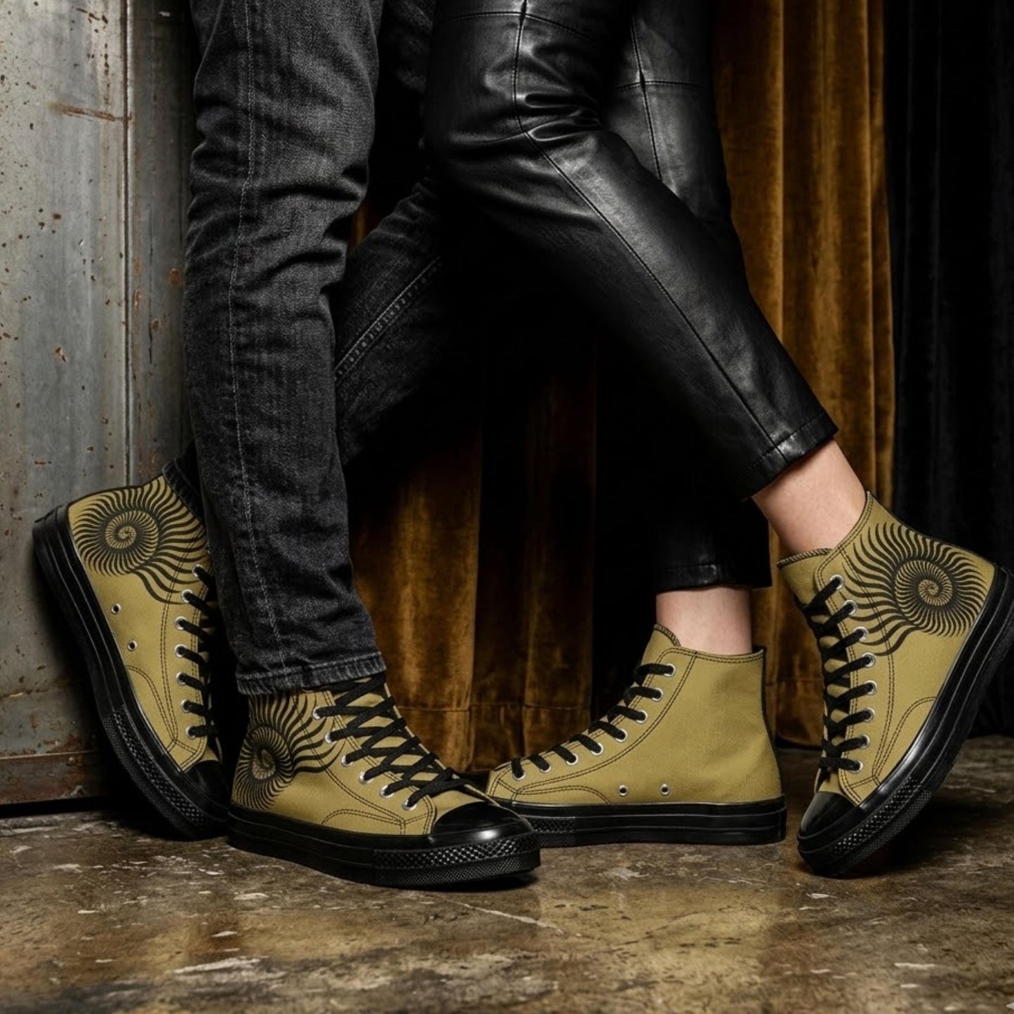 A pair of yellow and black sneakers with a spiral design on the side, standing on a concrete floor against a dark background.