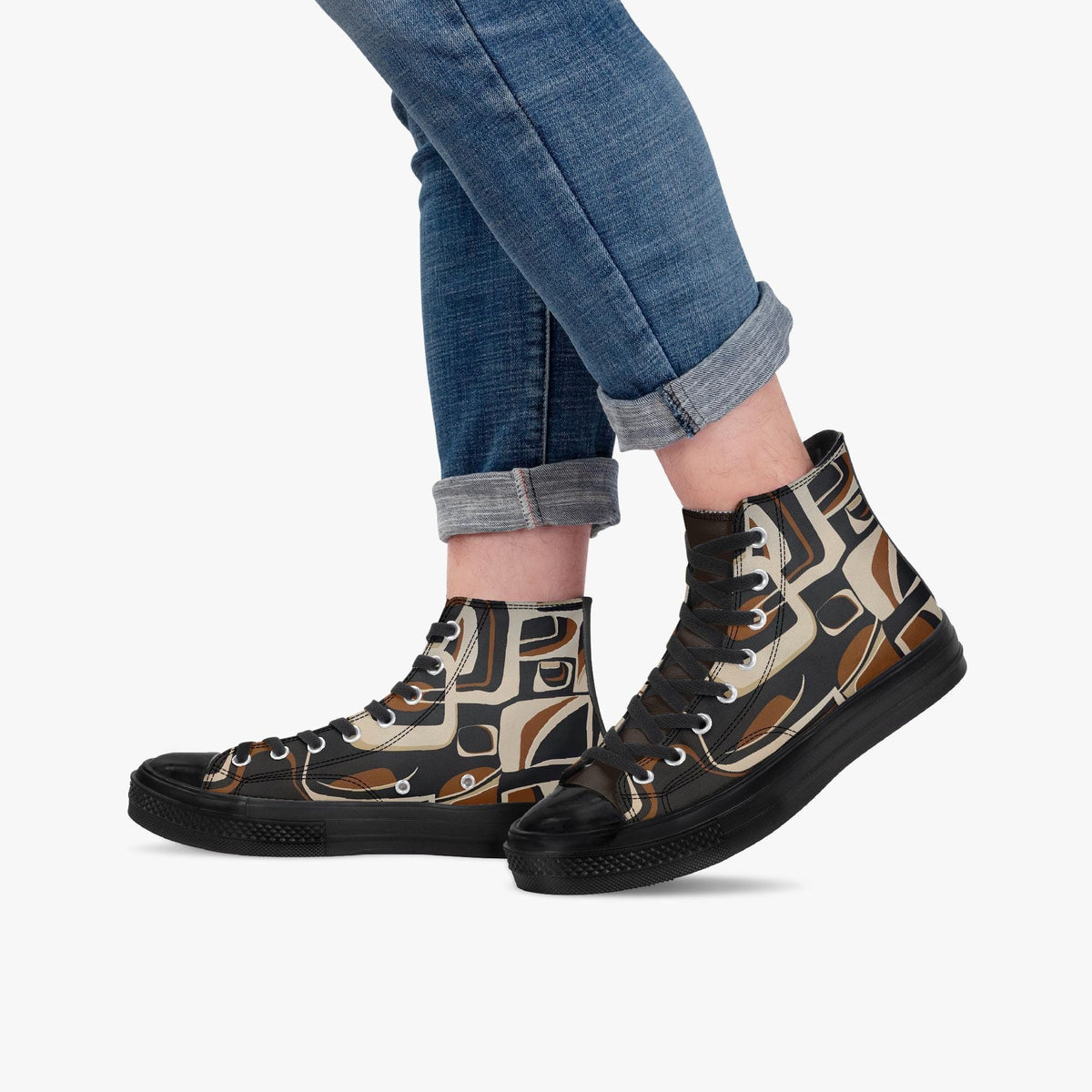 A person wearing blue jeans and black and brown patterned high-top sneakers.