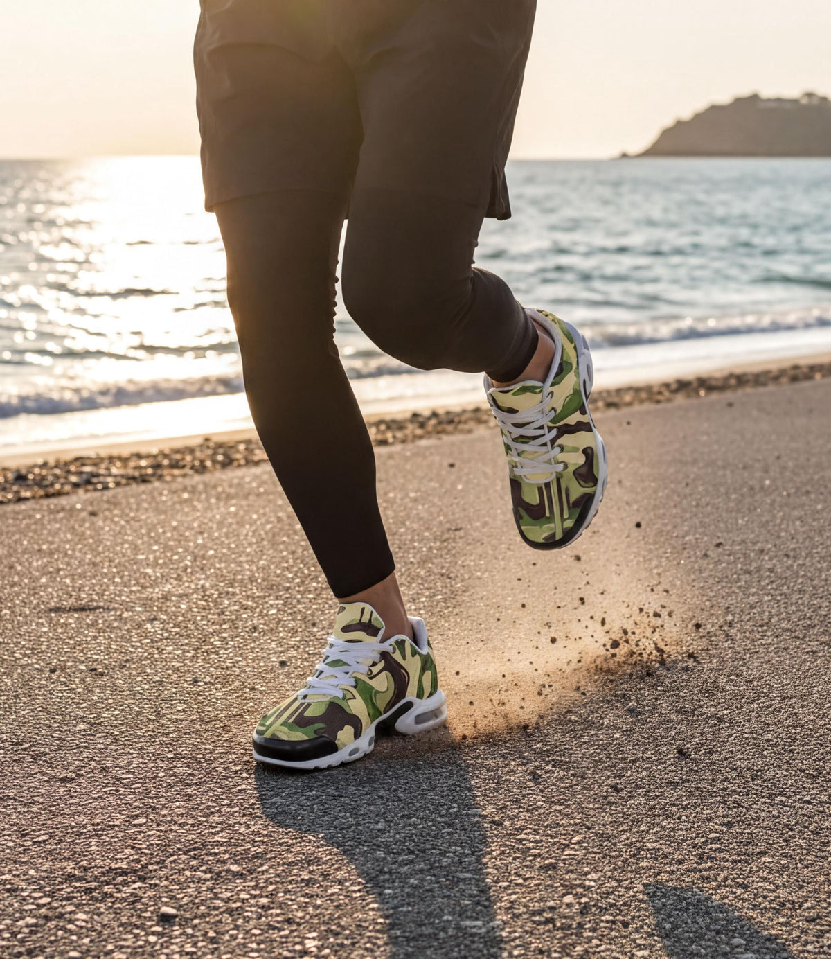 A person wearing camouflage running shoes is jogging on a beach near the ocean, with the sun setting in the background.