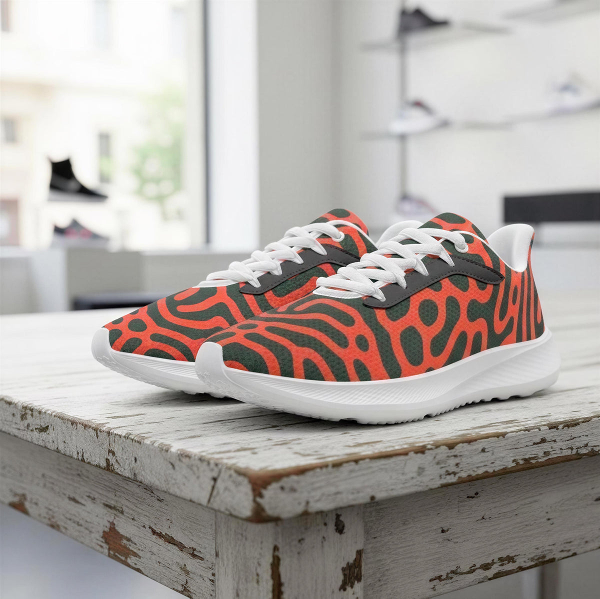 A pair of colorful, patterned sneakers with a bold, animal-inspired design is displayed on a wooden table.