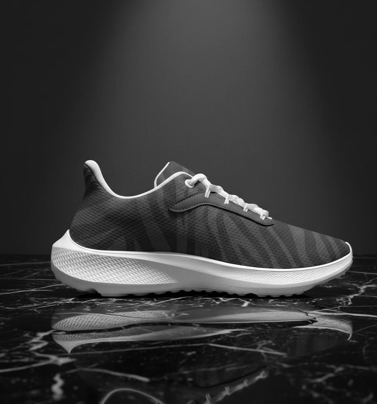 A black and white image of a sneaker with a distinctive zebra print pattern, displayed on a reflective surface.