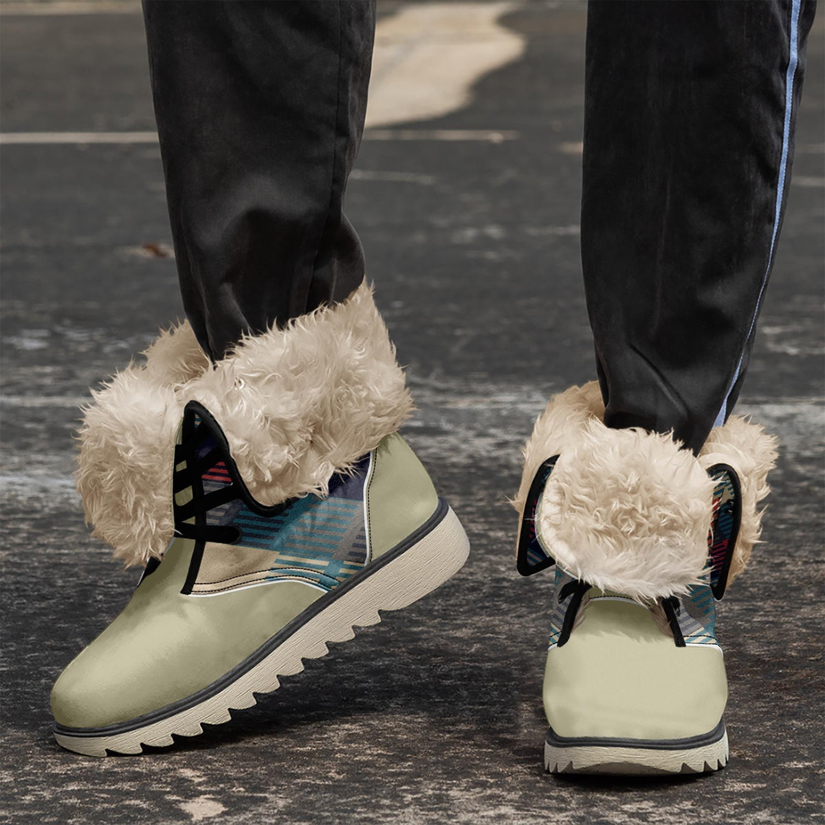 A pair of white furry boots with a colorful pattern on the side, standing on a gray surface.