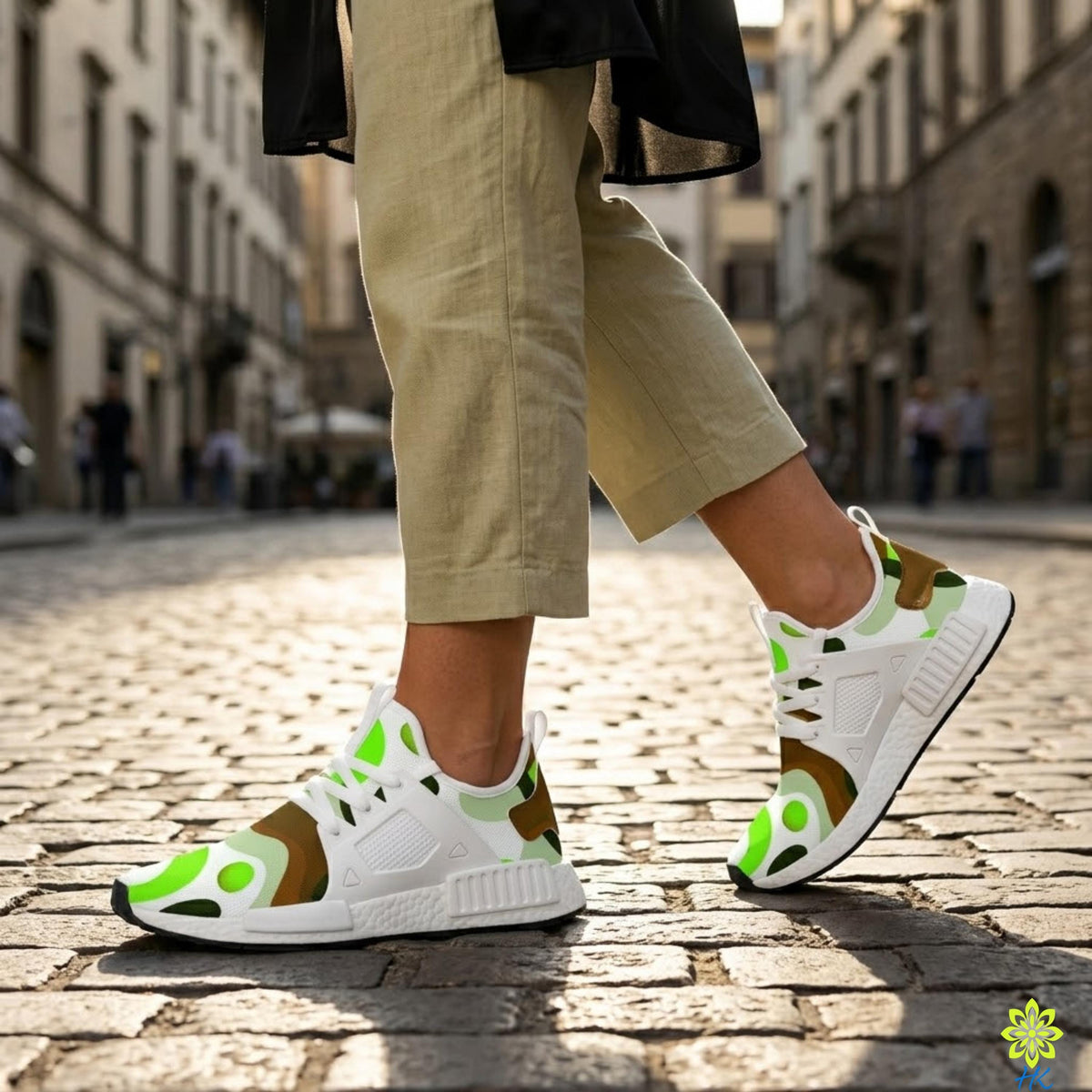 A person wearing camouflage sneakers is walking on a cobblestone street.