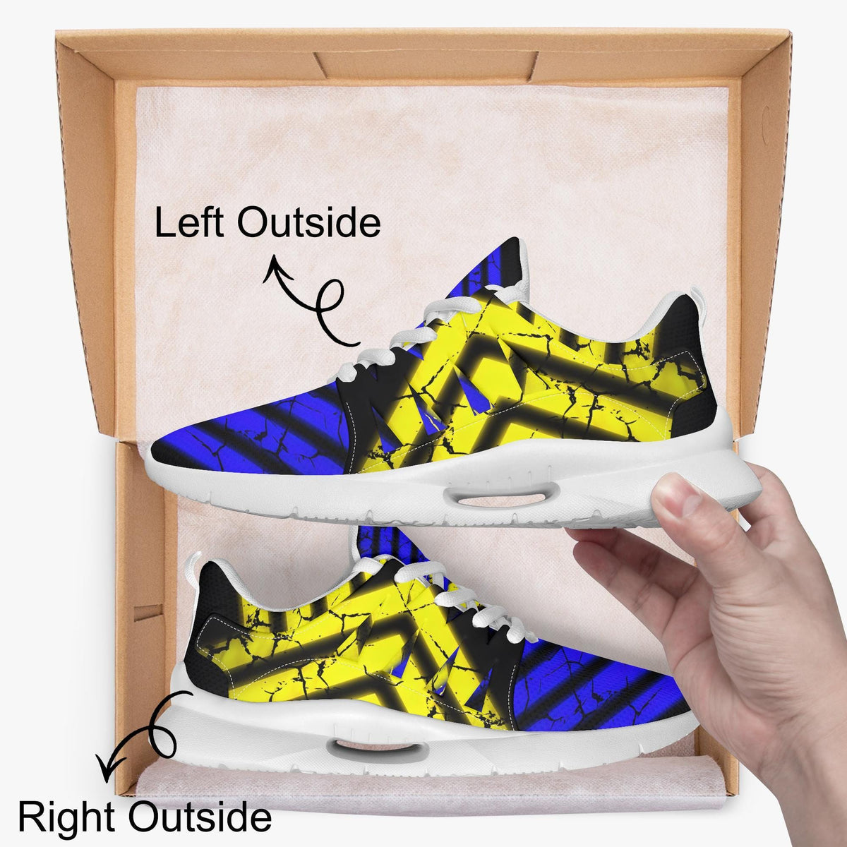 A hand is holding a pair of colorful sneakers with a bold, abstract design in yellow, blue, and black.