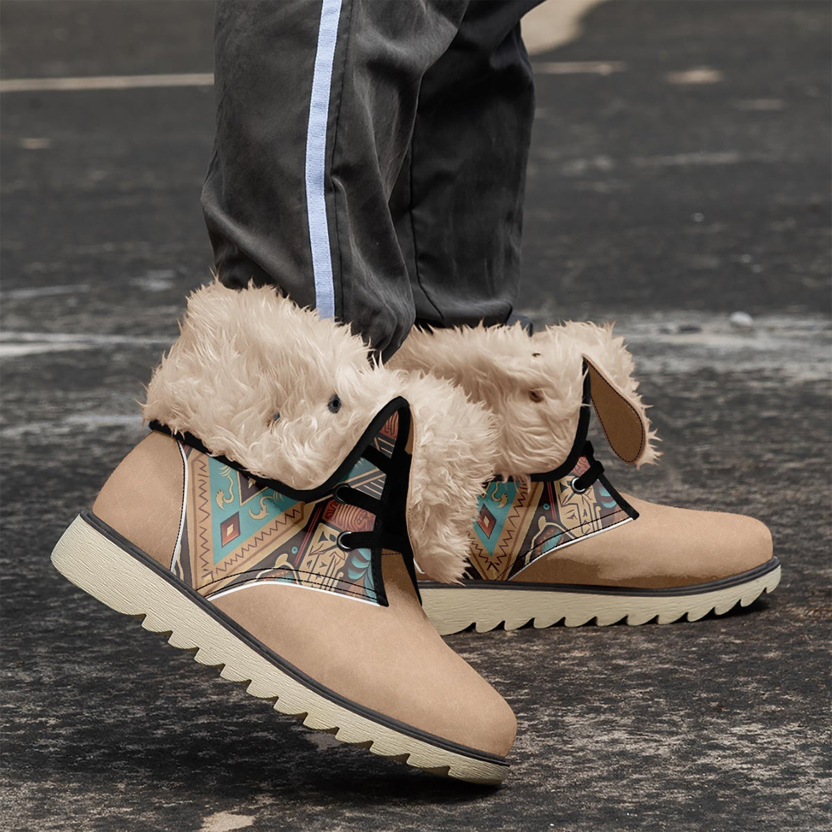 A close-up of a person's feet wearing tan boots with fur trim and colorful, patterned designs on the sides.