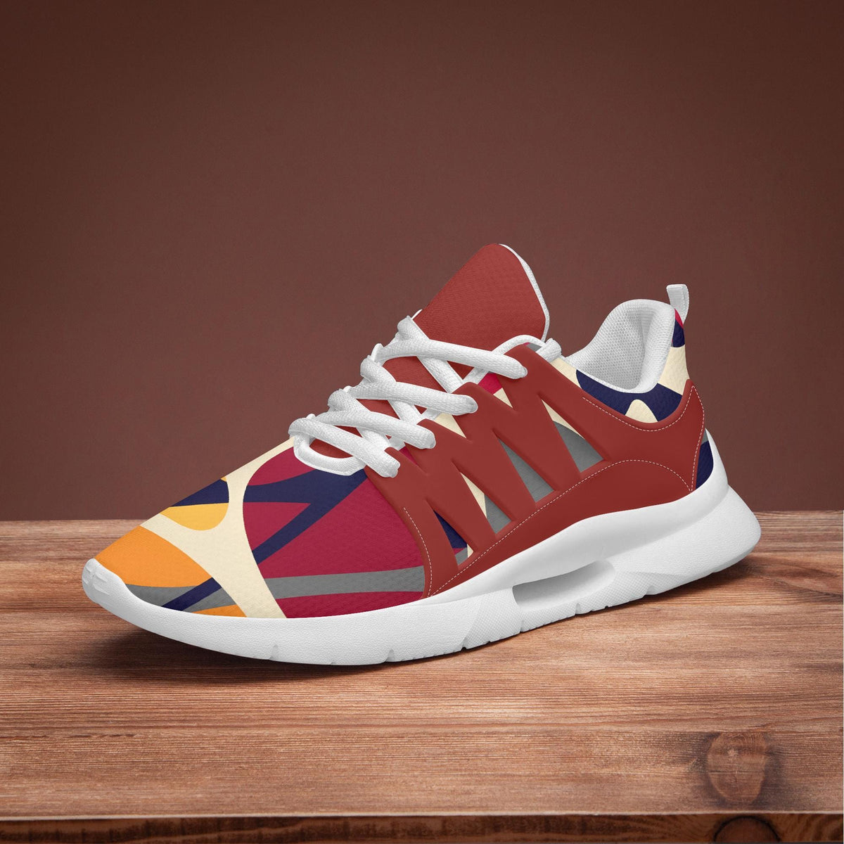 A colorful and patterned sneaker is displayed on a wooden surface against a brown background.