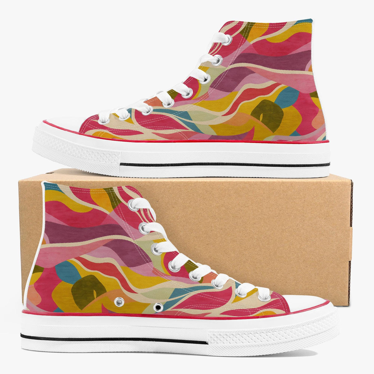 A pair of high-top canvas sneakers with a colorful abstract wavy pattern in pink, yellow, orange, and blue, displayed with one shoe on top of and one in front of a brown cardboard box on a white background.