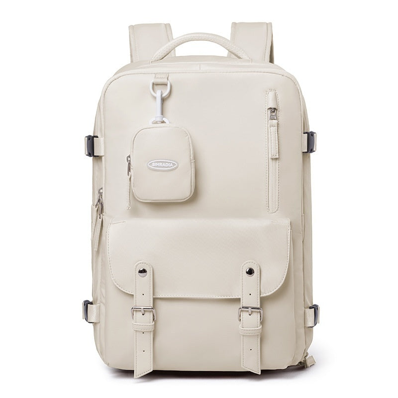 Front view of apricot white travel backpack with detachable pouch, zipper pocket and buckle-detail flap