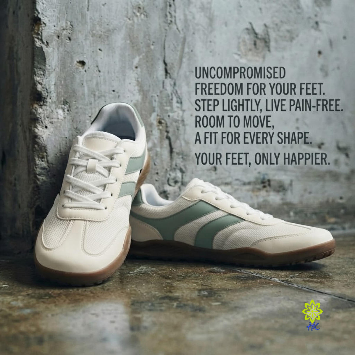 A pair of low-top athletic sneakers in off-white and sage green, leaning against a textured concrete wall on a wet stone floor. Black text on the right reads, 'UNCOMPROMISED FREEDOM FOR YOUR FEET.