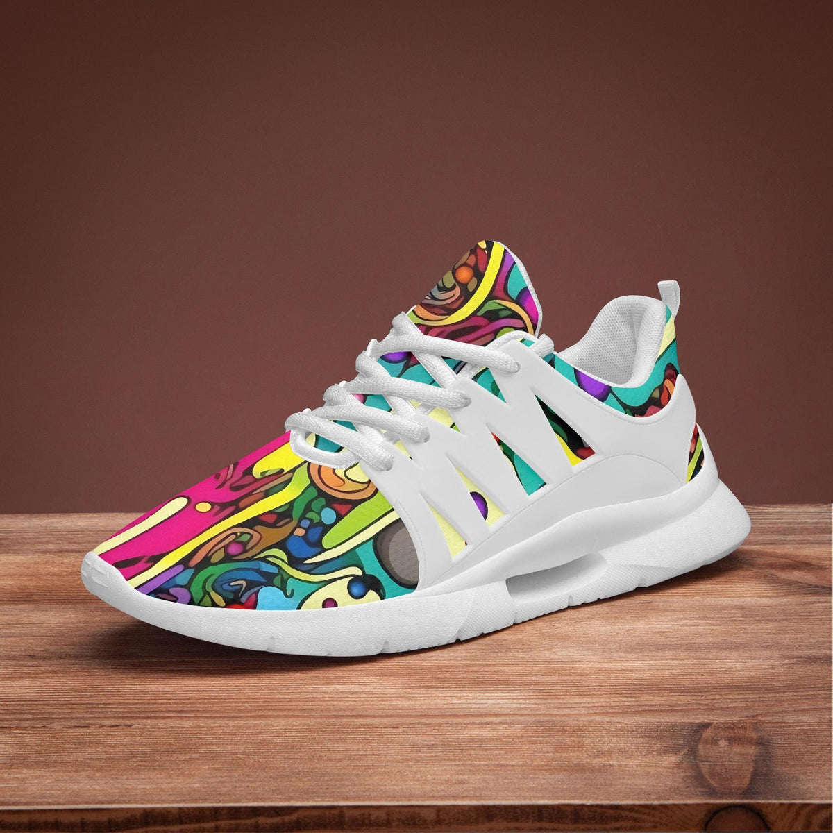 A colorful, patterned sneaker with a vibrant design on the side is displayed on a wooden surface.