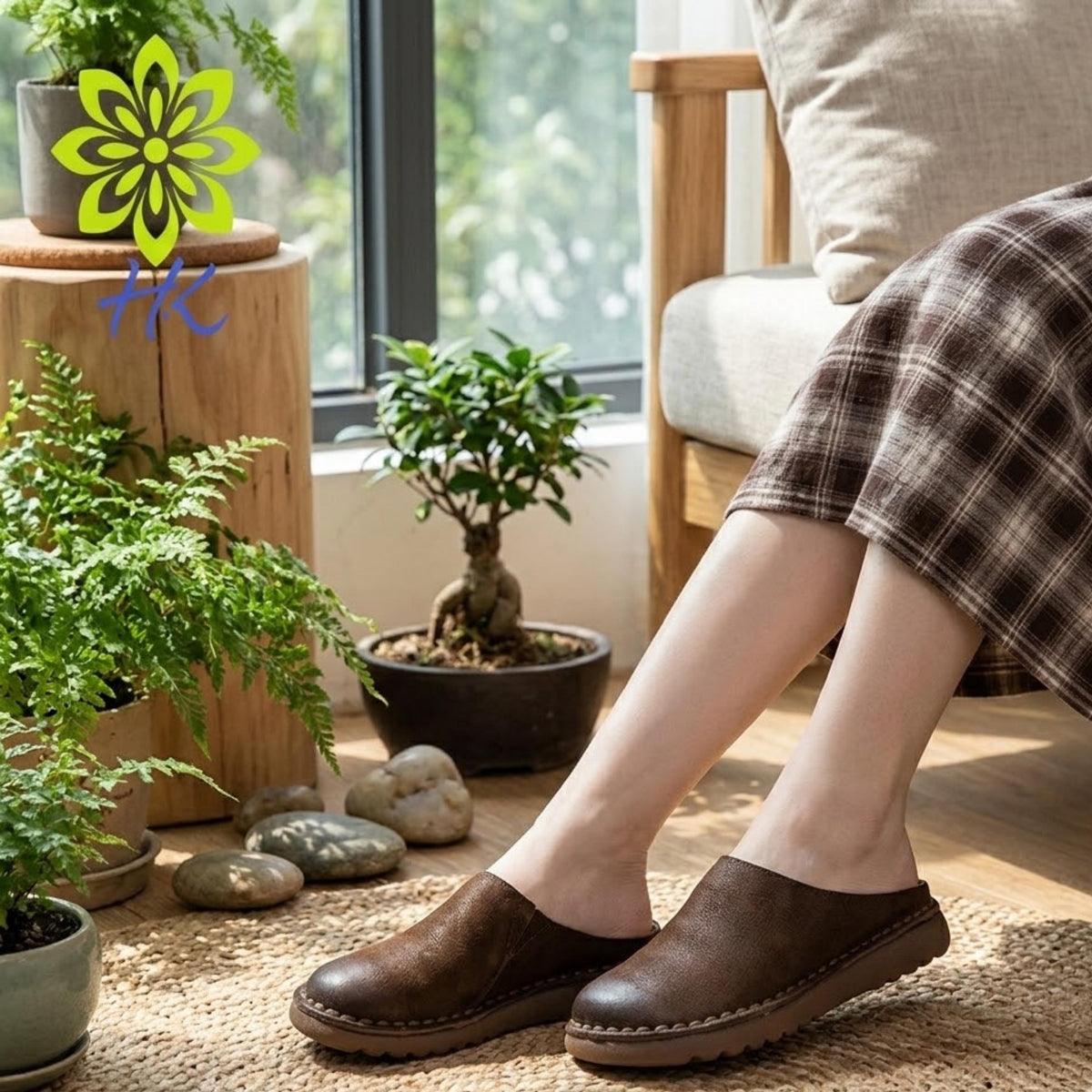 A person's legs wearing brown shoes are shown in a cozy indoor setting with potted plants, a wooden stool, and a large window.