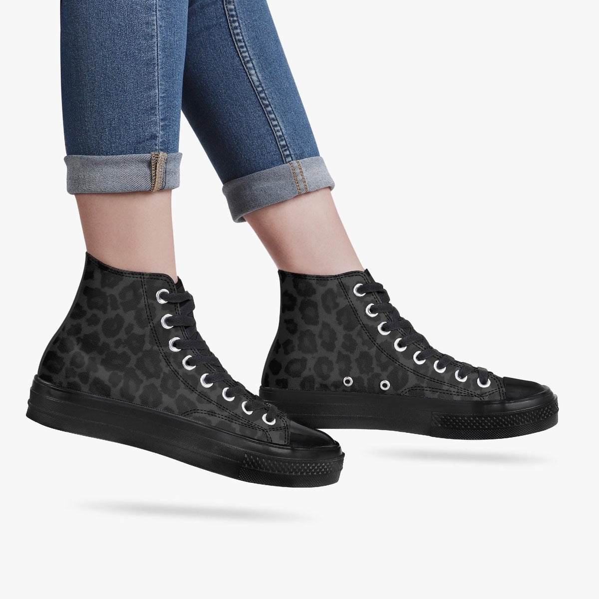 A pair of black high-top sneakers with a leopard print pattern.