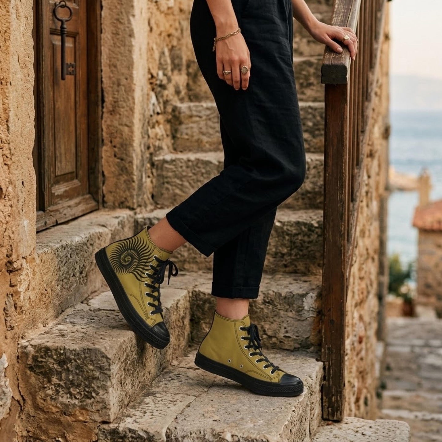A person wearing yellow and black sneakers is standing on stone steps next to a wooden railing.