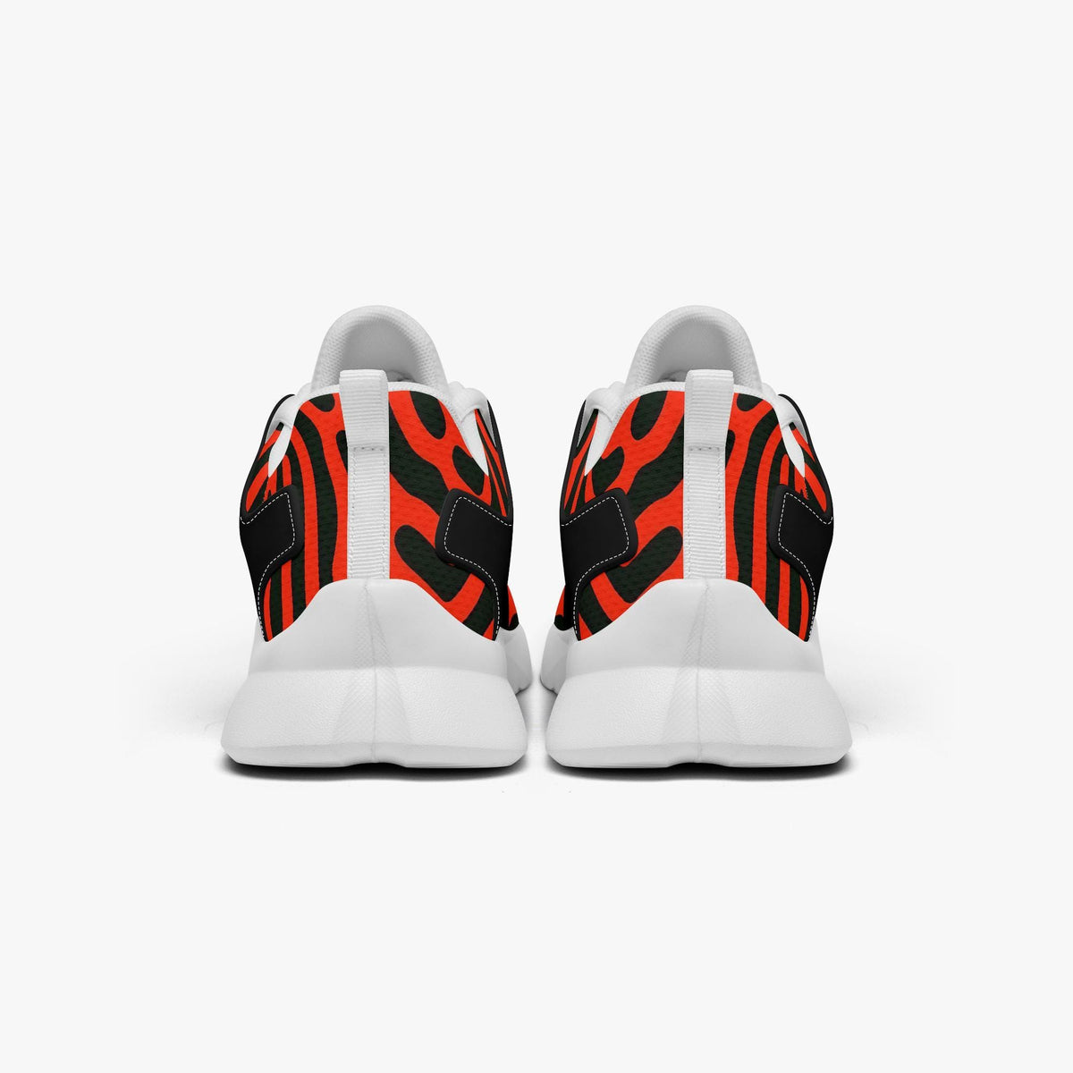 A pair of white sneakers with a striking black and orange zebra print design.