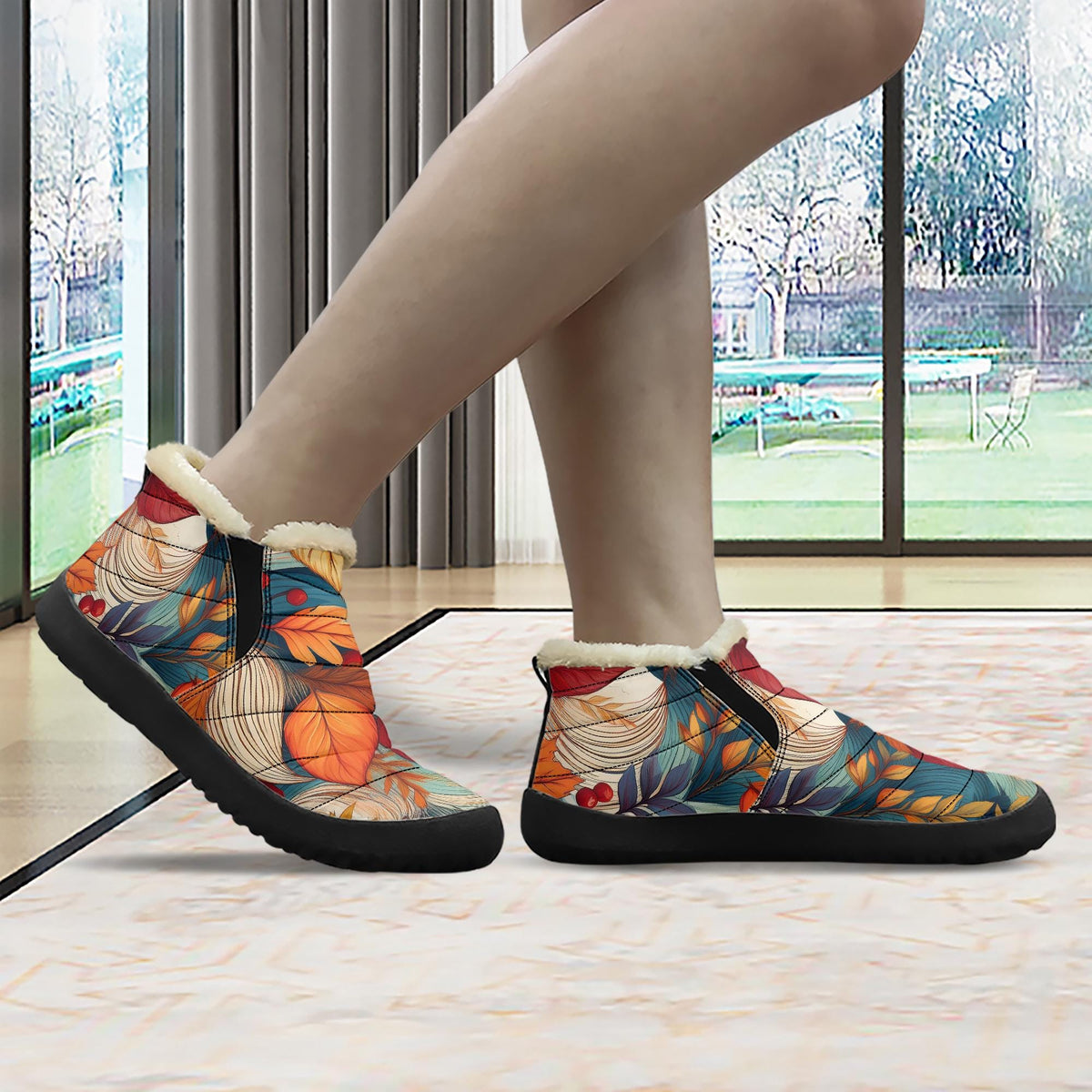A person's feet wearing colorful, patterned boots with a floral design.
