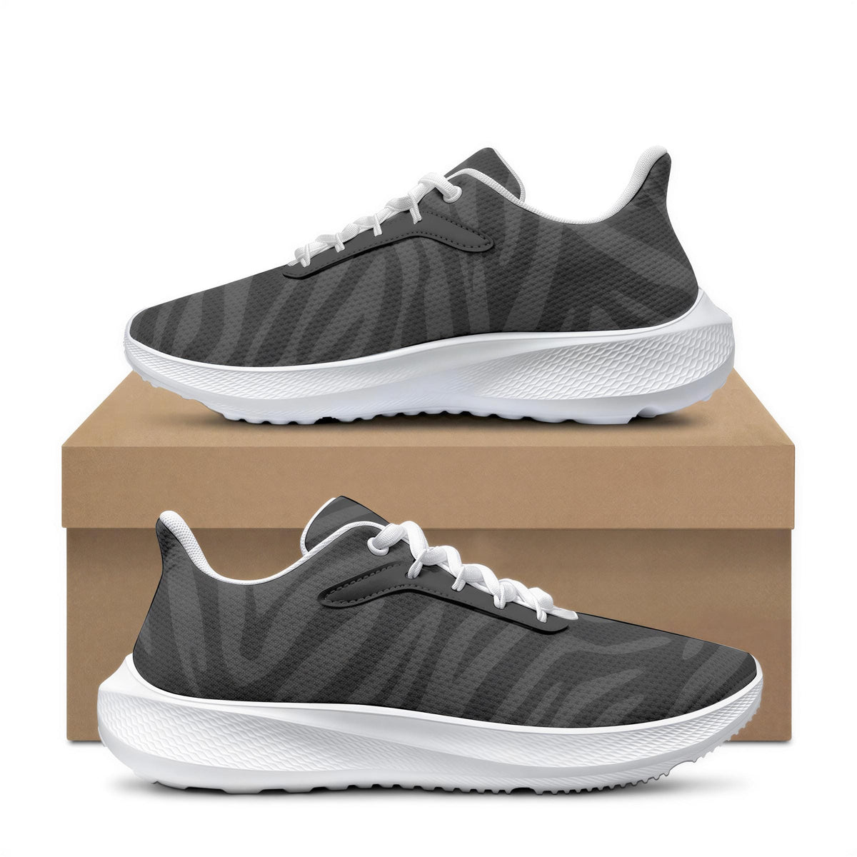 A pair of gray and white sneakers placed on top of a cardboard box.