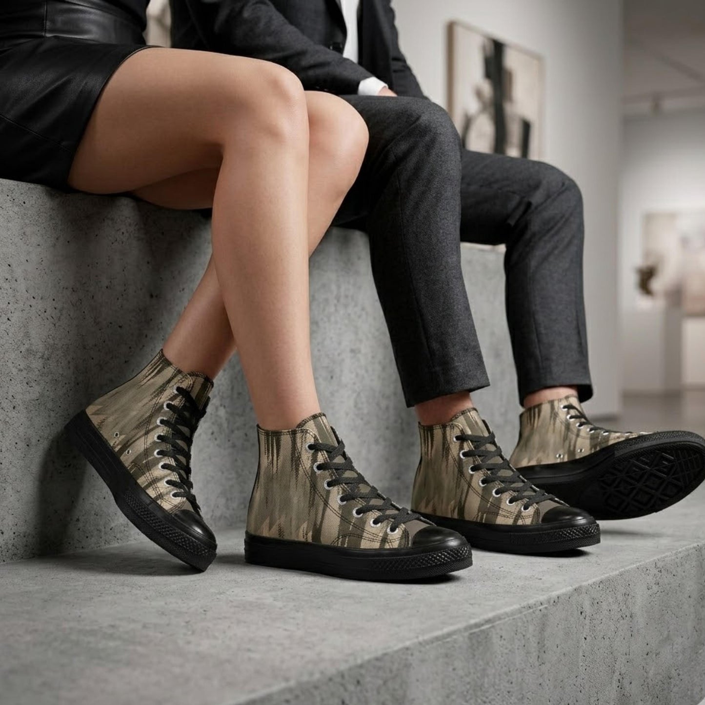 A pair of legs wearing camouflage-patterned high-top sneakers, sitting on a concrete ledge.