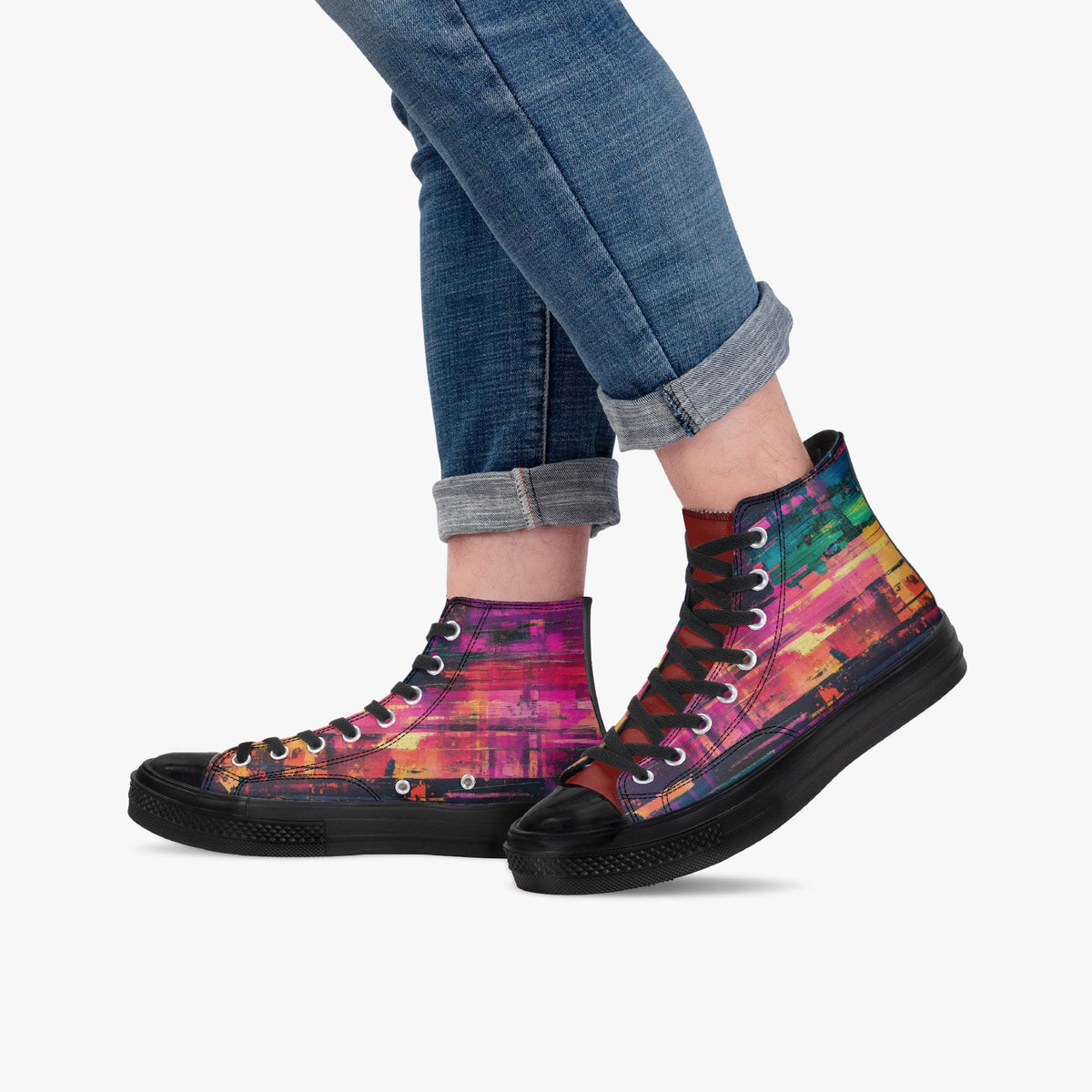 A person wearing blue jeans and colorful high-top sneakers with a vibrant, abstract pattern.