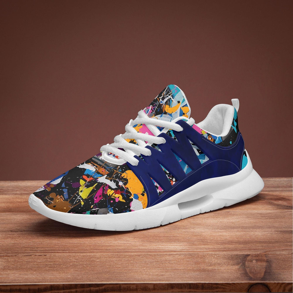 A colorful and patterned sneaker with a vibrant design on the side, displayed on a wooden surface.