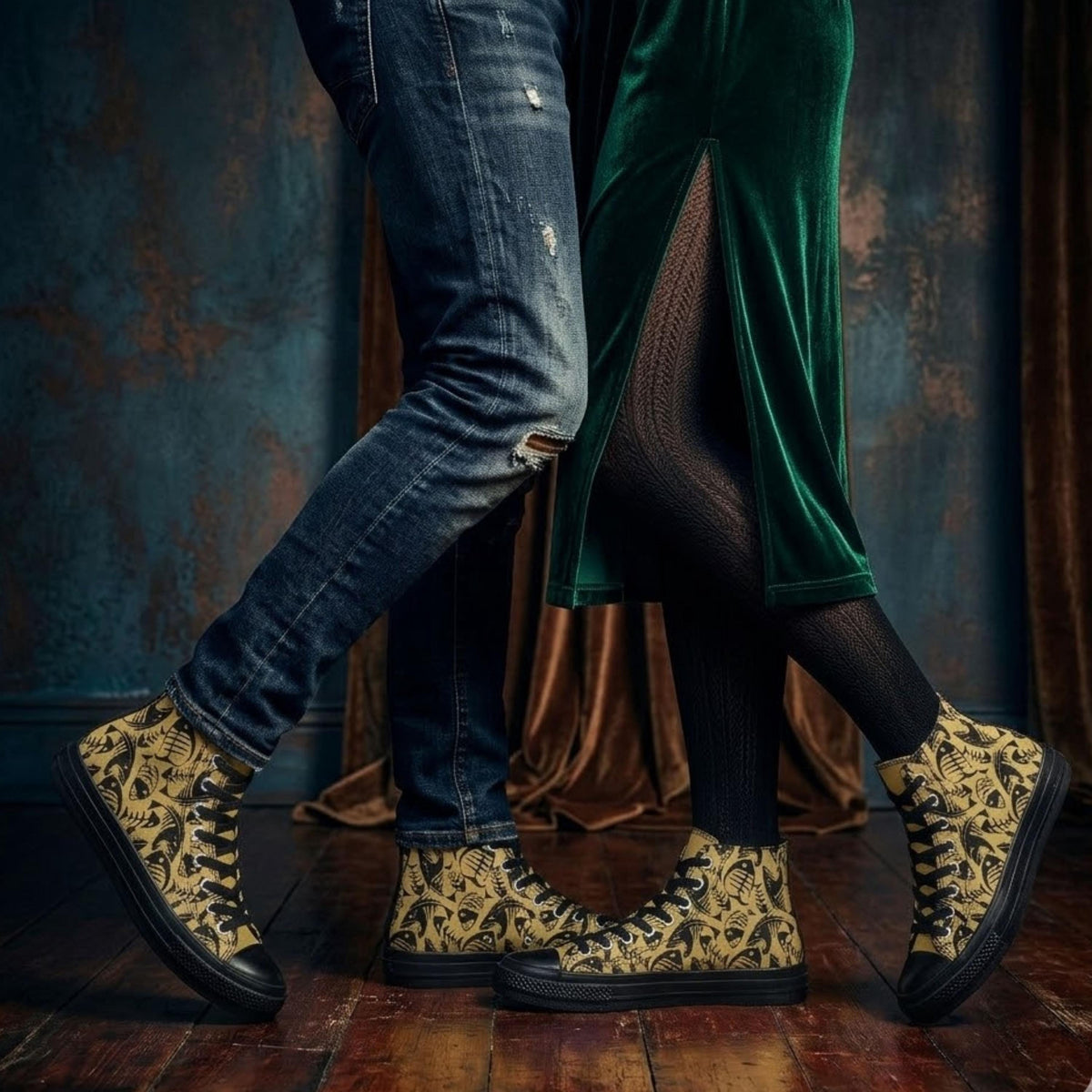 A close-up of two people wearing patterned shoes, one in a green velvet dress and the other in blue jeans, standing on a wooden floor against a dark background.