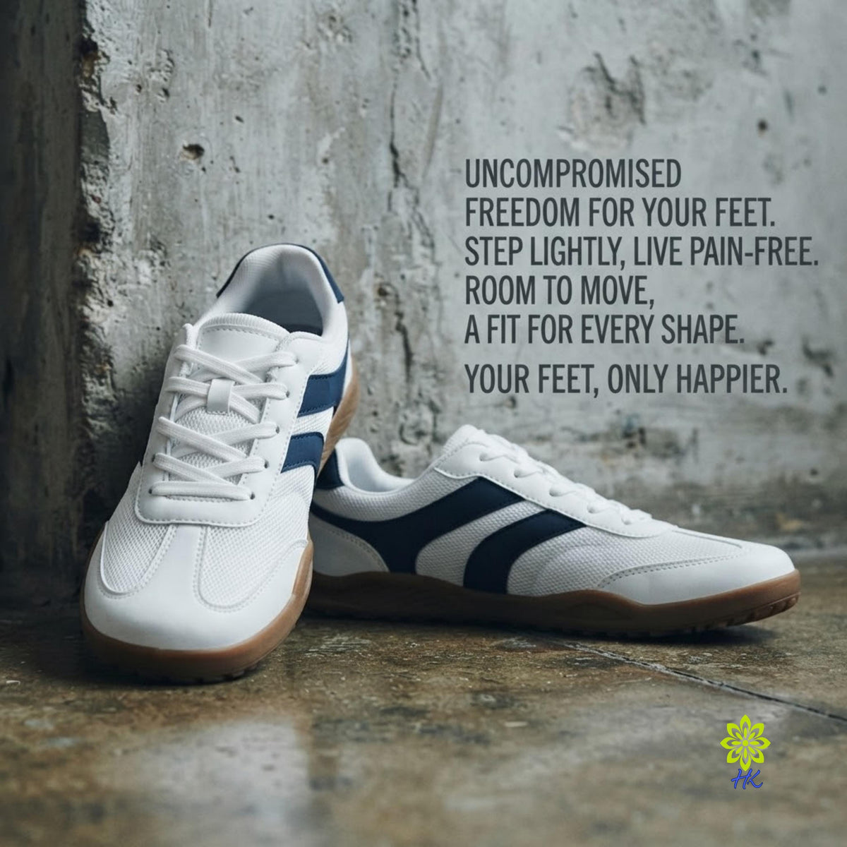 A pair of white low-top athletic shoes with navy blue side stripes and gum soles, photographed on a textured concrete floor against a weathered wall. Black text on the right reads, 'UNCOMPROMISED FREEDOM FOR YOUR FEET.