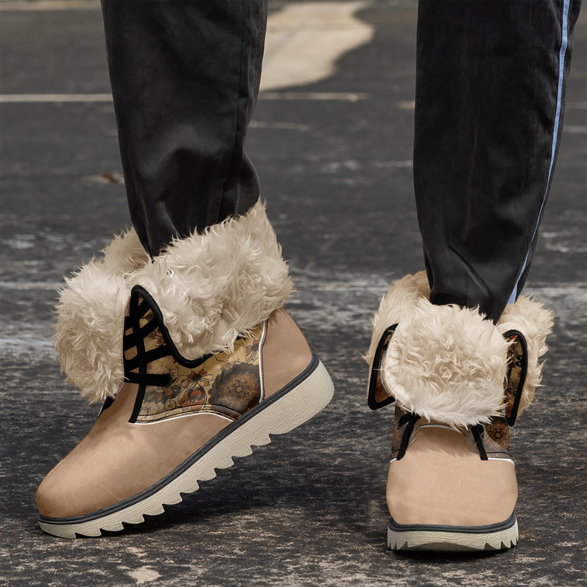 A pair of tan boots with fur trim, worn by a person standing on a gray surface.