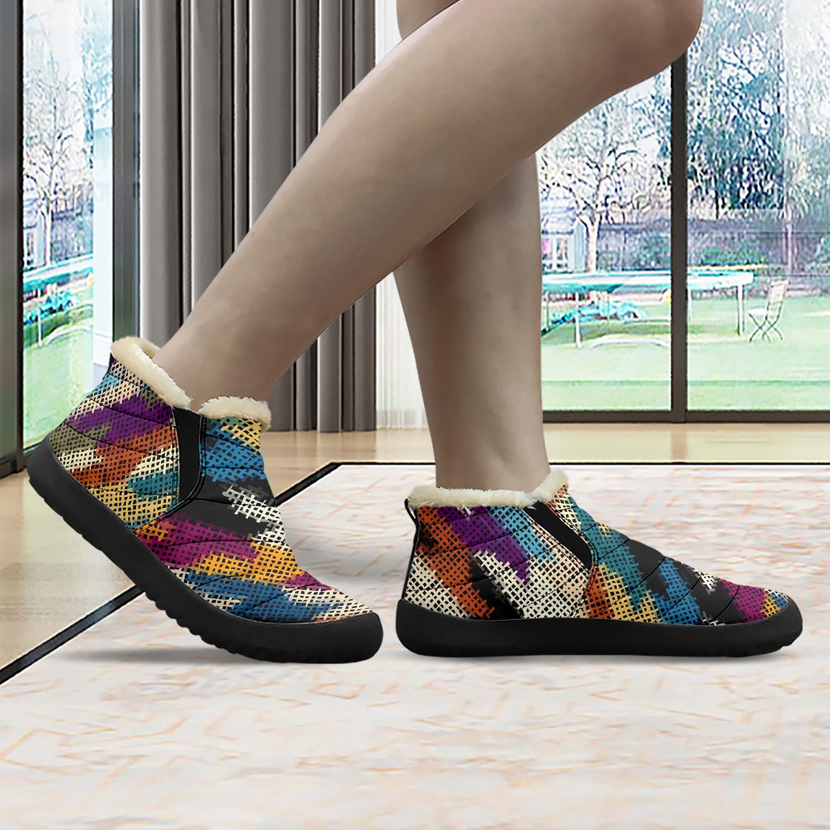 A person's feet wearing colorful, patterned, and textured shoes are shown in the image.