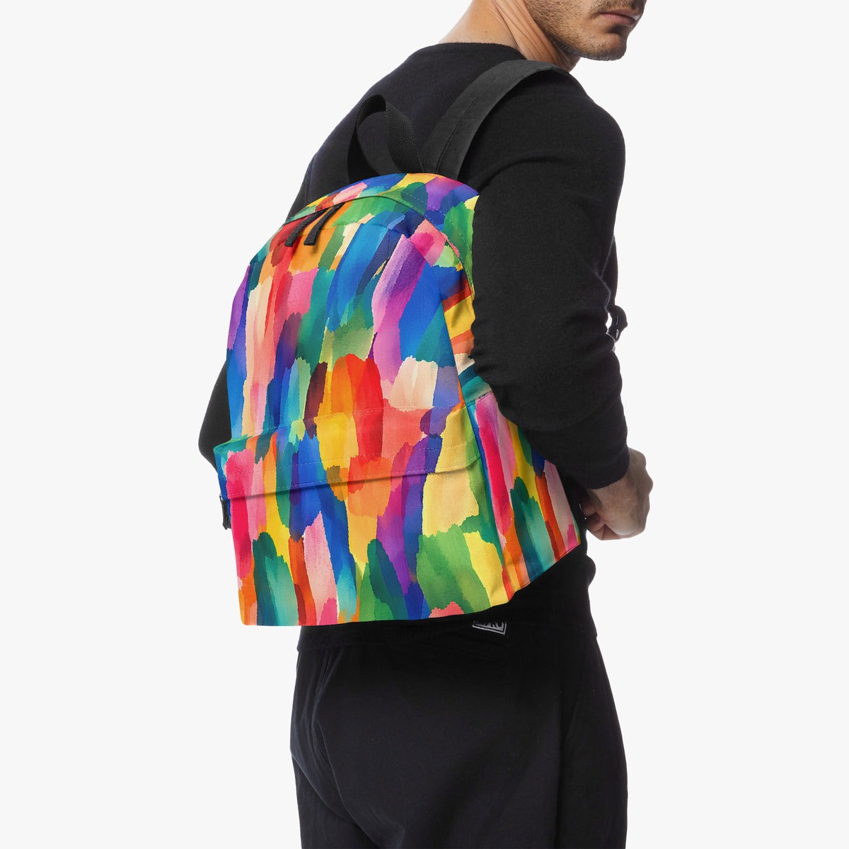 Man in a black sweatshirt wearing a colorful backpack