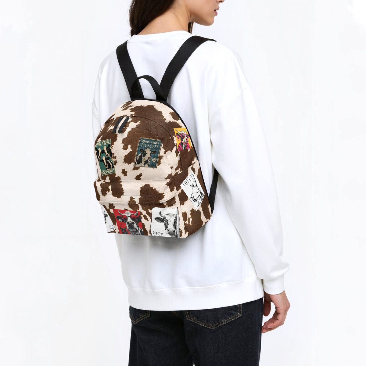 Mochilas de vaca en tallas S, M y L junto a una tableta de referencia