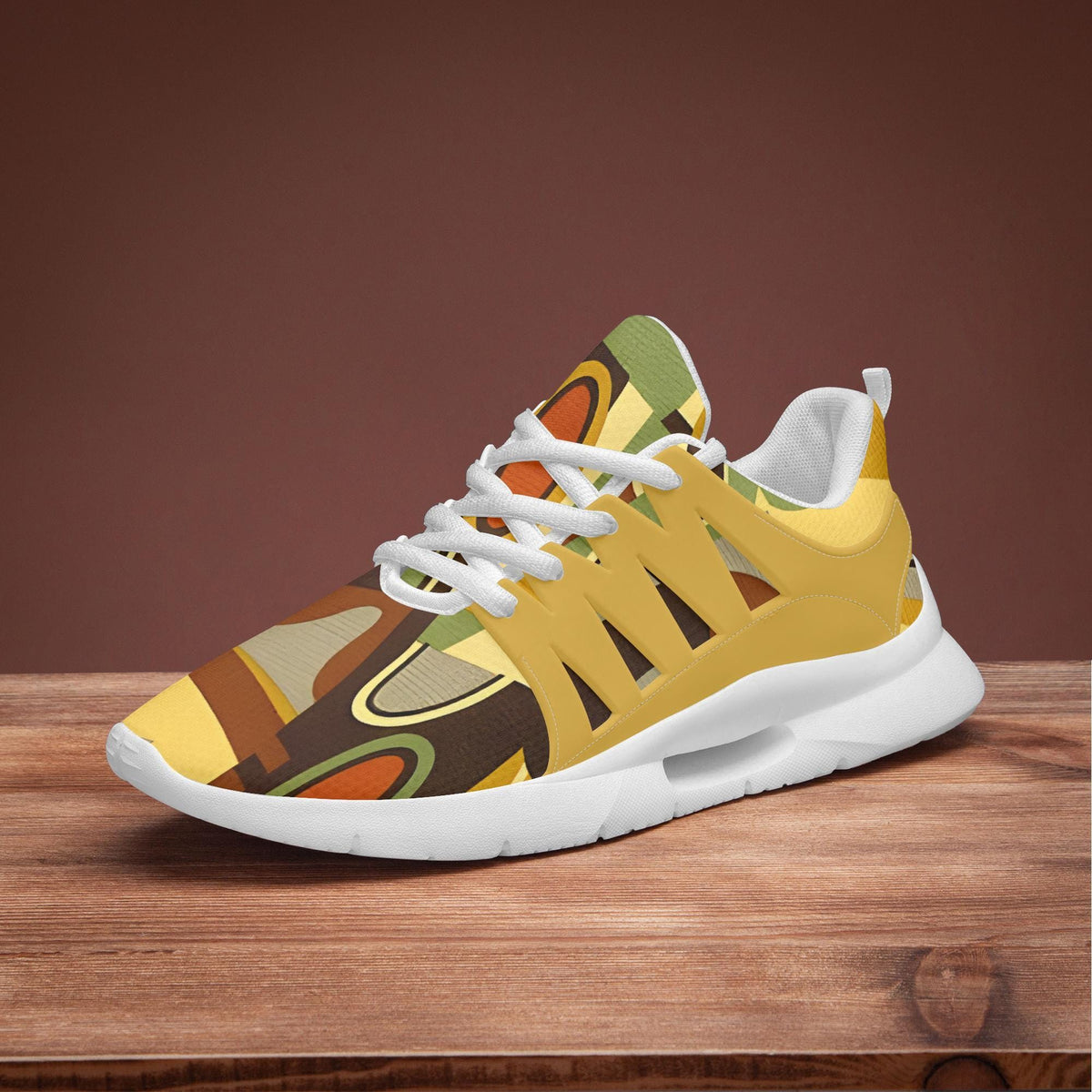 A colorful, abstract-patterned sneaker is displayed on a wooden surface against a brown background.