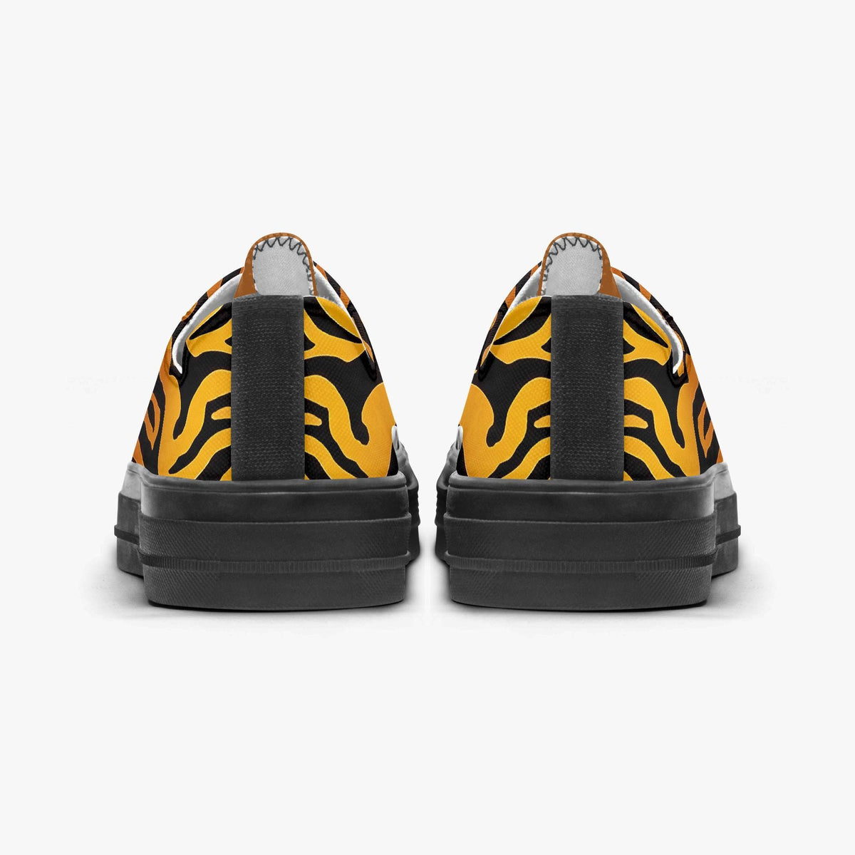 the back view of a pair of black and yellow tiger-striped canvas shoes.