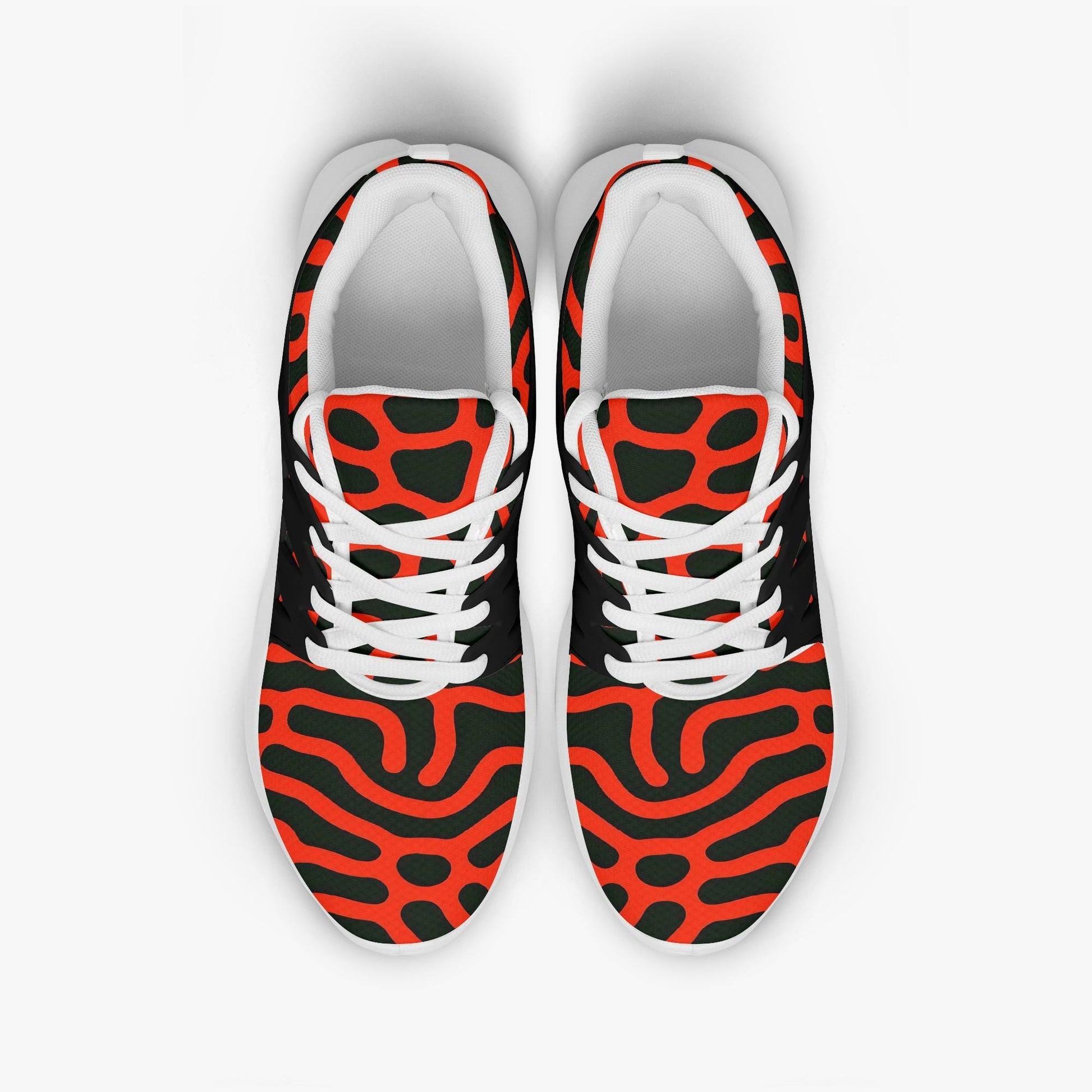 A pair of colorful sneakers with a bold, abstract pattern in red, black, and white.