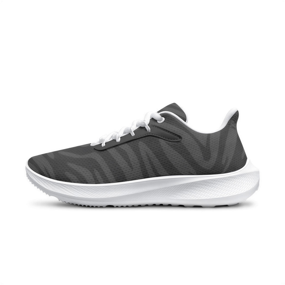 A single black and white sneaker with a zebra print pattern.