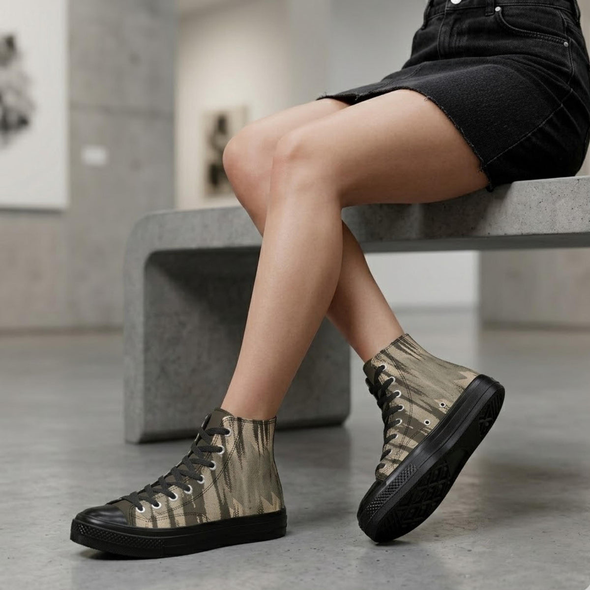 A person sitting on a bench wearing high-top sneakers with a camouflage pattern.