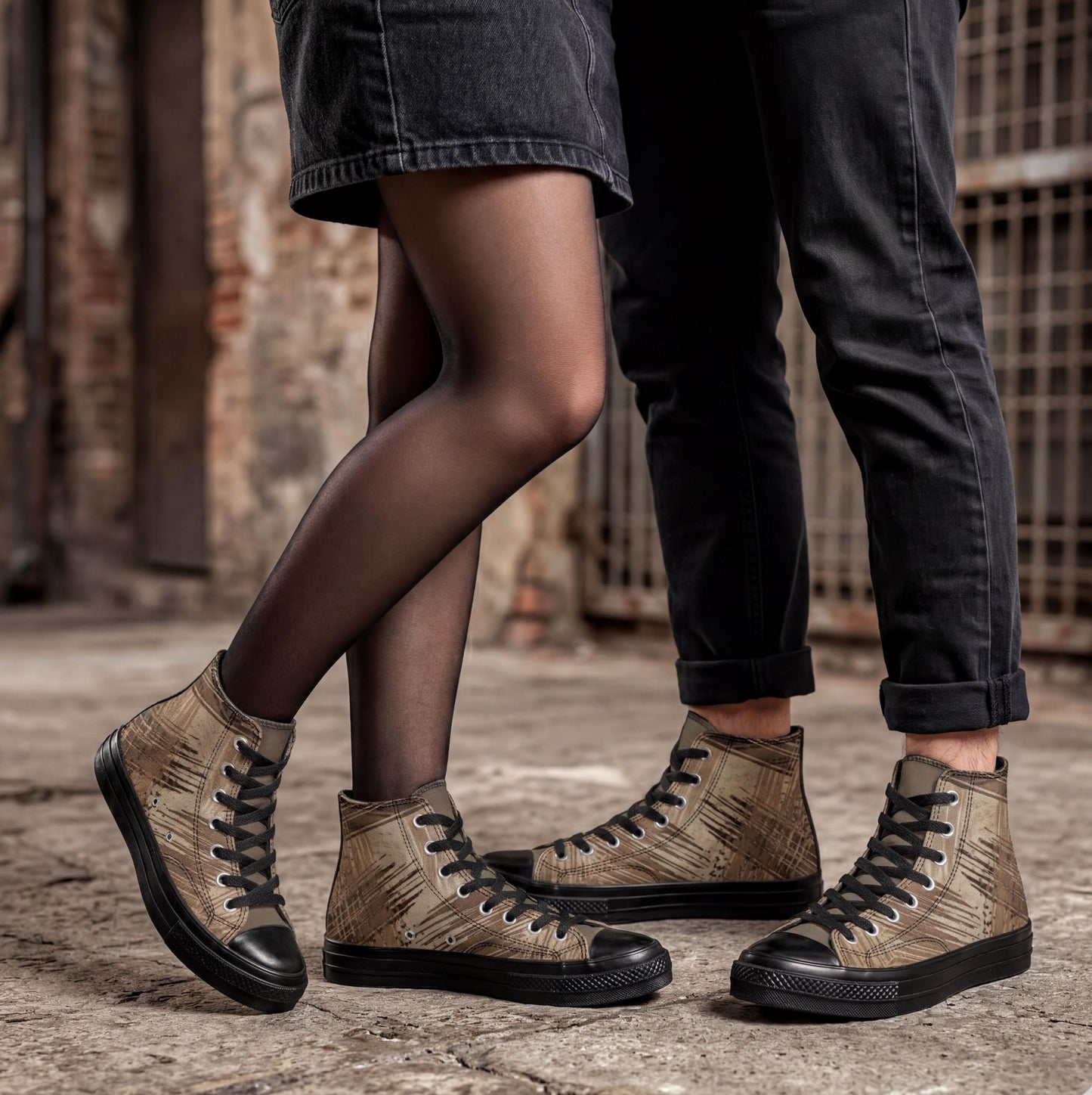 A close-up of two people wearing black jeans and tan high-top sneakers, standing side by side.