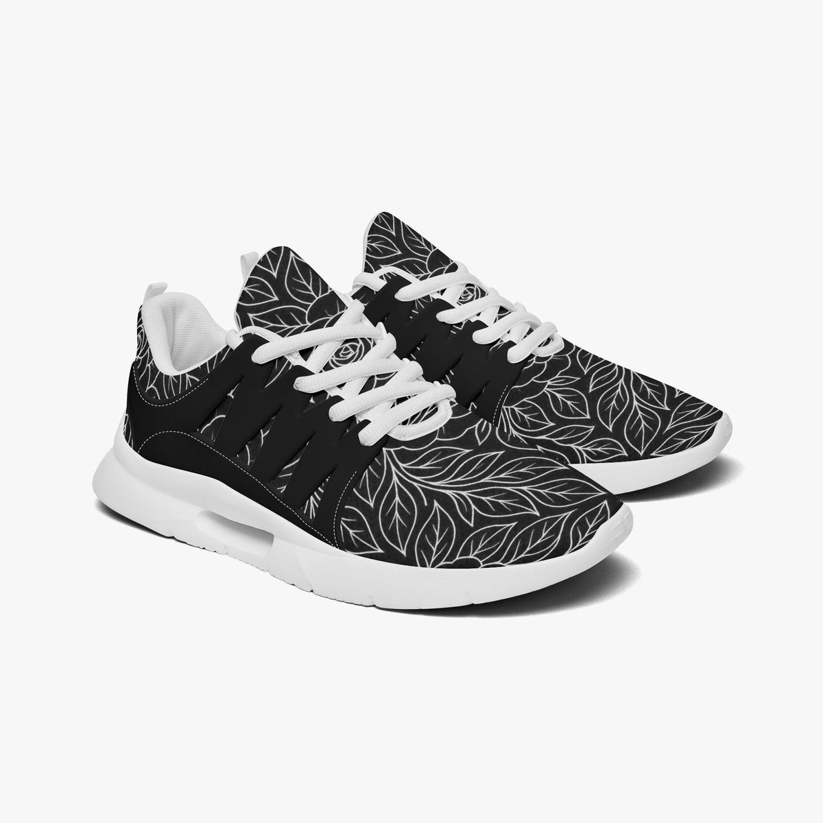 A pair of black and white sneakers with a leaf pattern design.