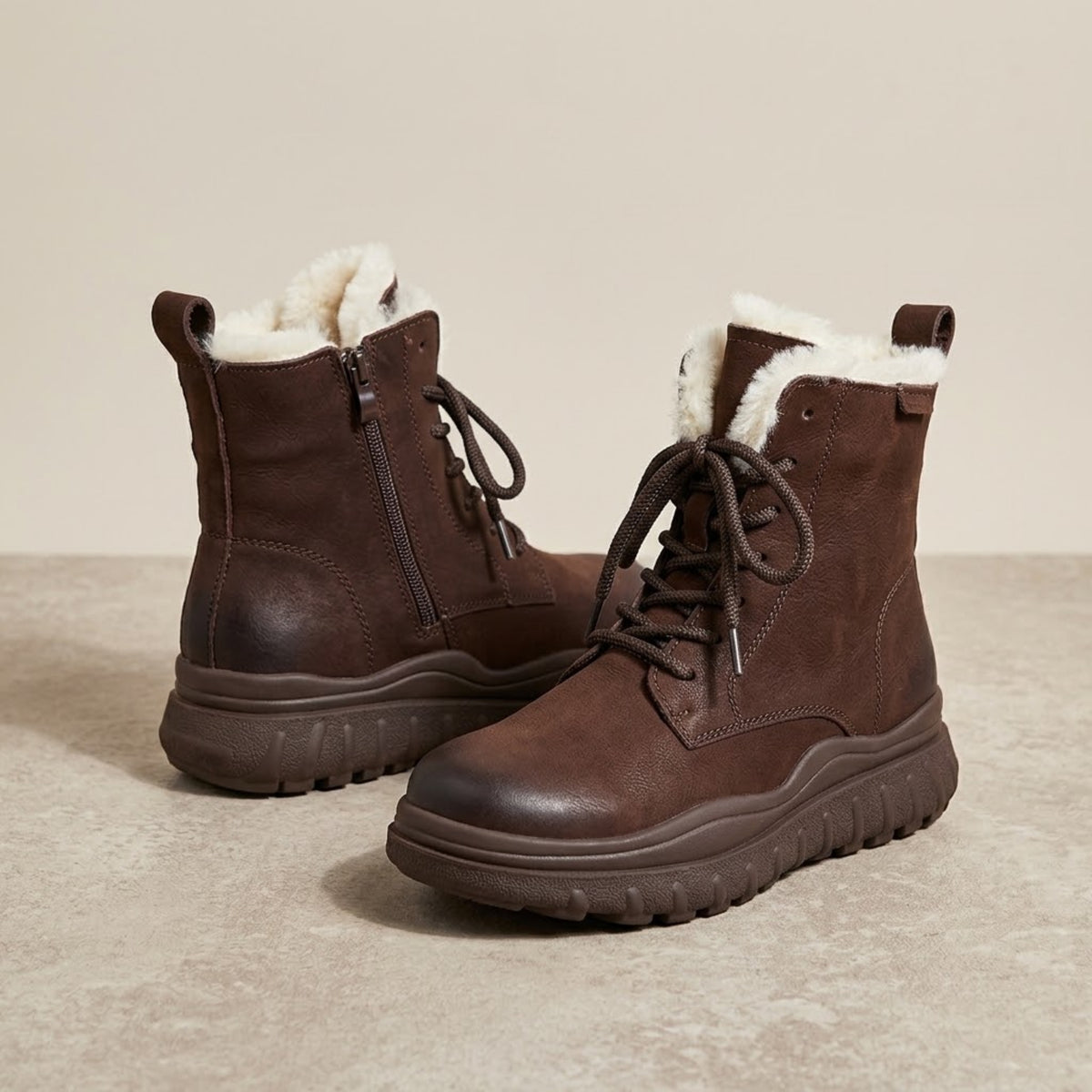 Darker coffee brown pair of platform snow boots on a beige background