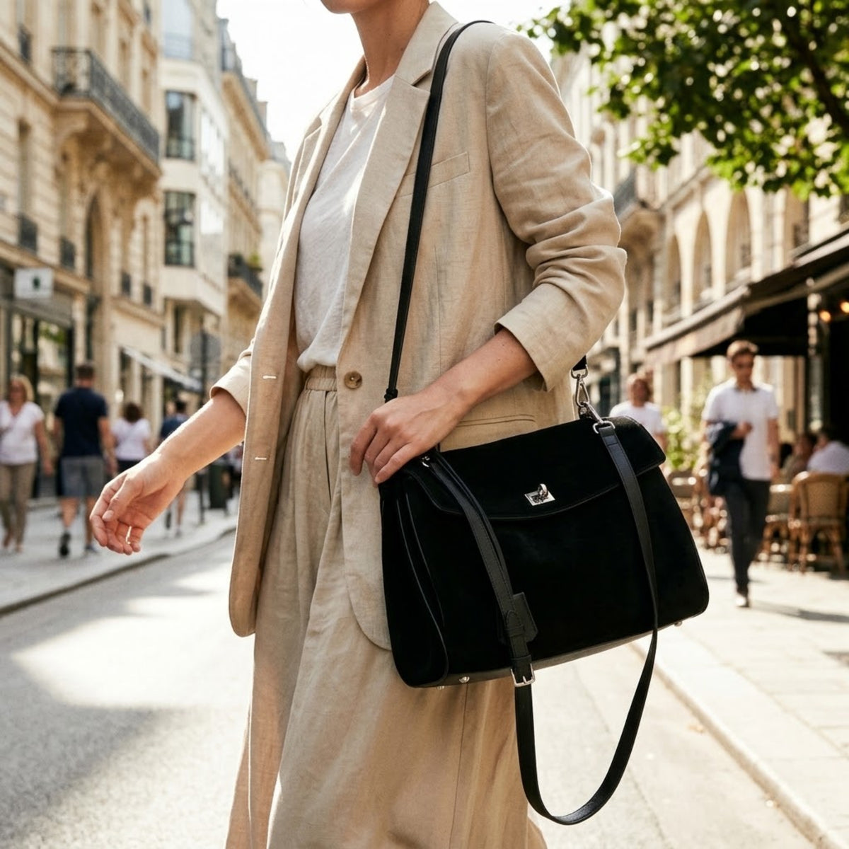 Black suede shoulder bag in a three-quarter view