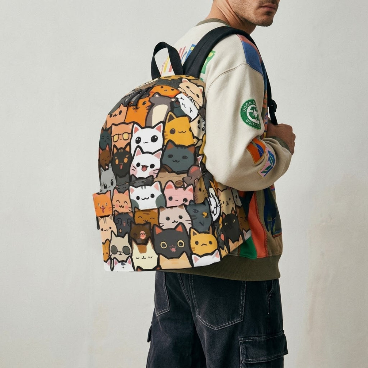 Model wearing cat print backpack against a grey wall