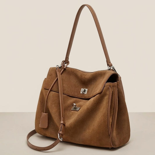 Brown suede shoulder bag shown in a three-quarter view on a white background