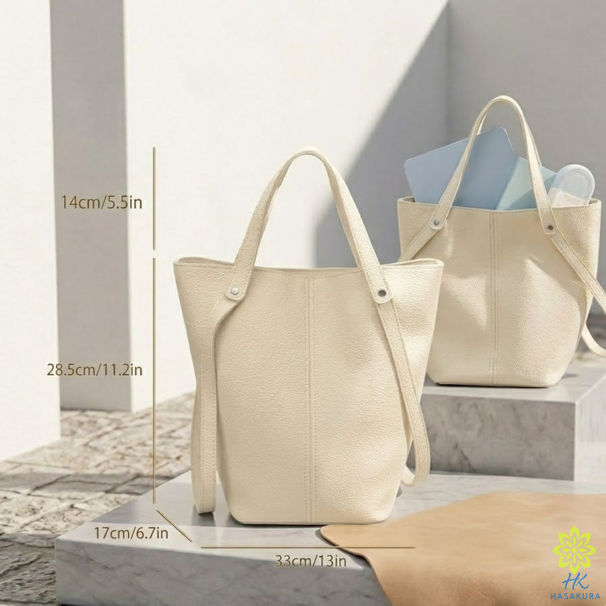 Black tote bag styled for a formal evening look with a cream suit