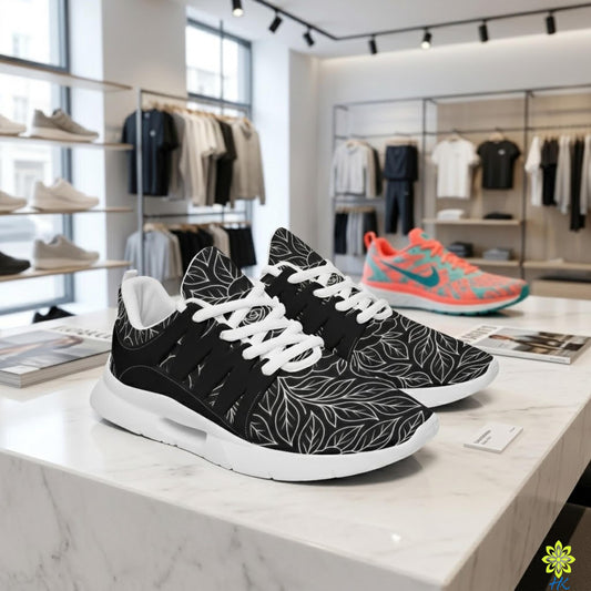 A pair of black and white sneakers with leaf patterns displayed on a marble countertop in a retail store, with various clothing items visible in the background.