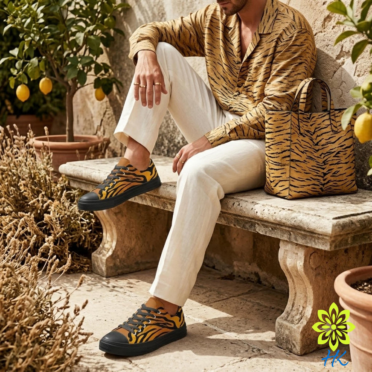 A person is sitting on a stone bench, wearing a tiger print shirt and white pants, with a tiger print handbag beside them.