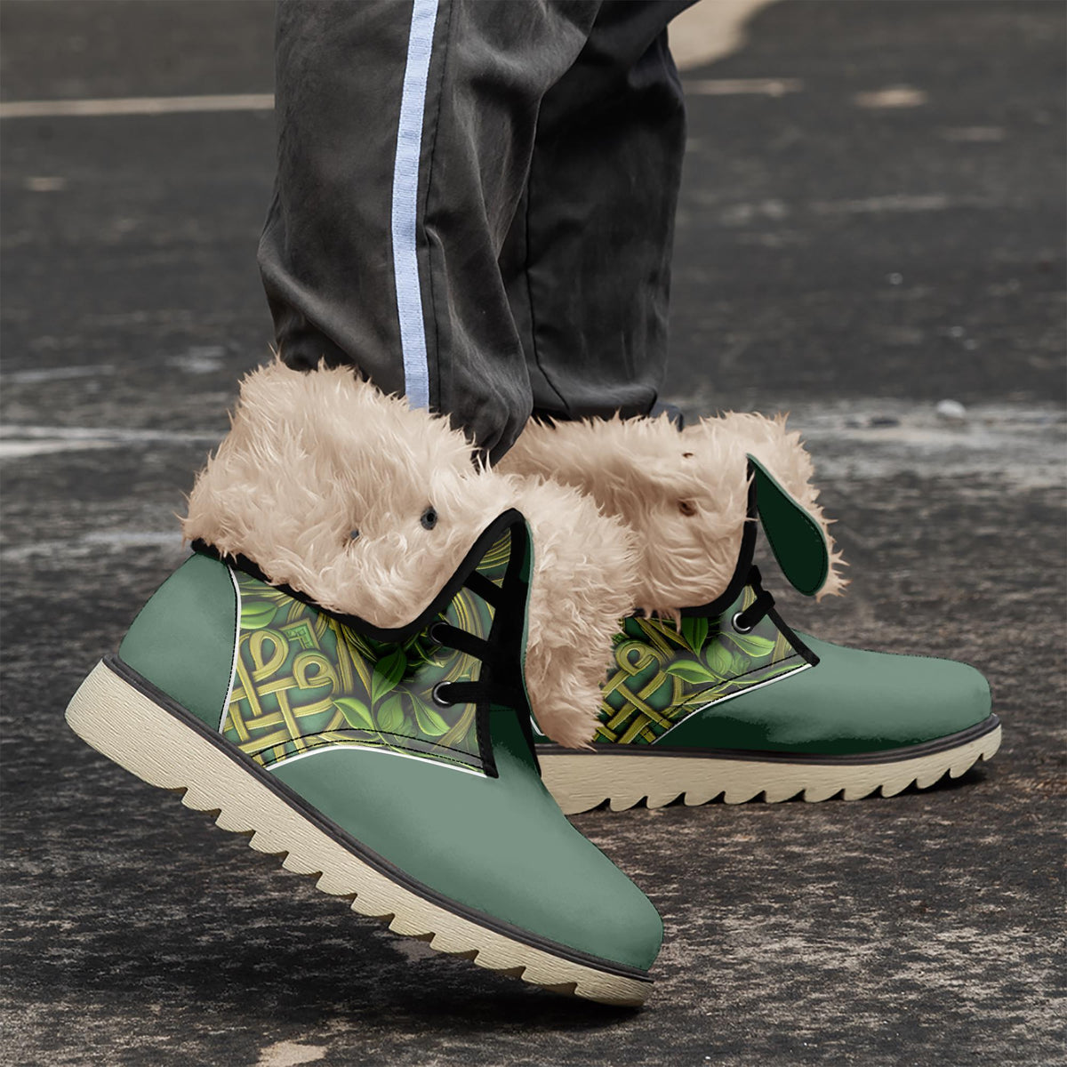 A pair of green and white boots with fur lining, worn by a person standing on a paved surface.