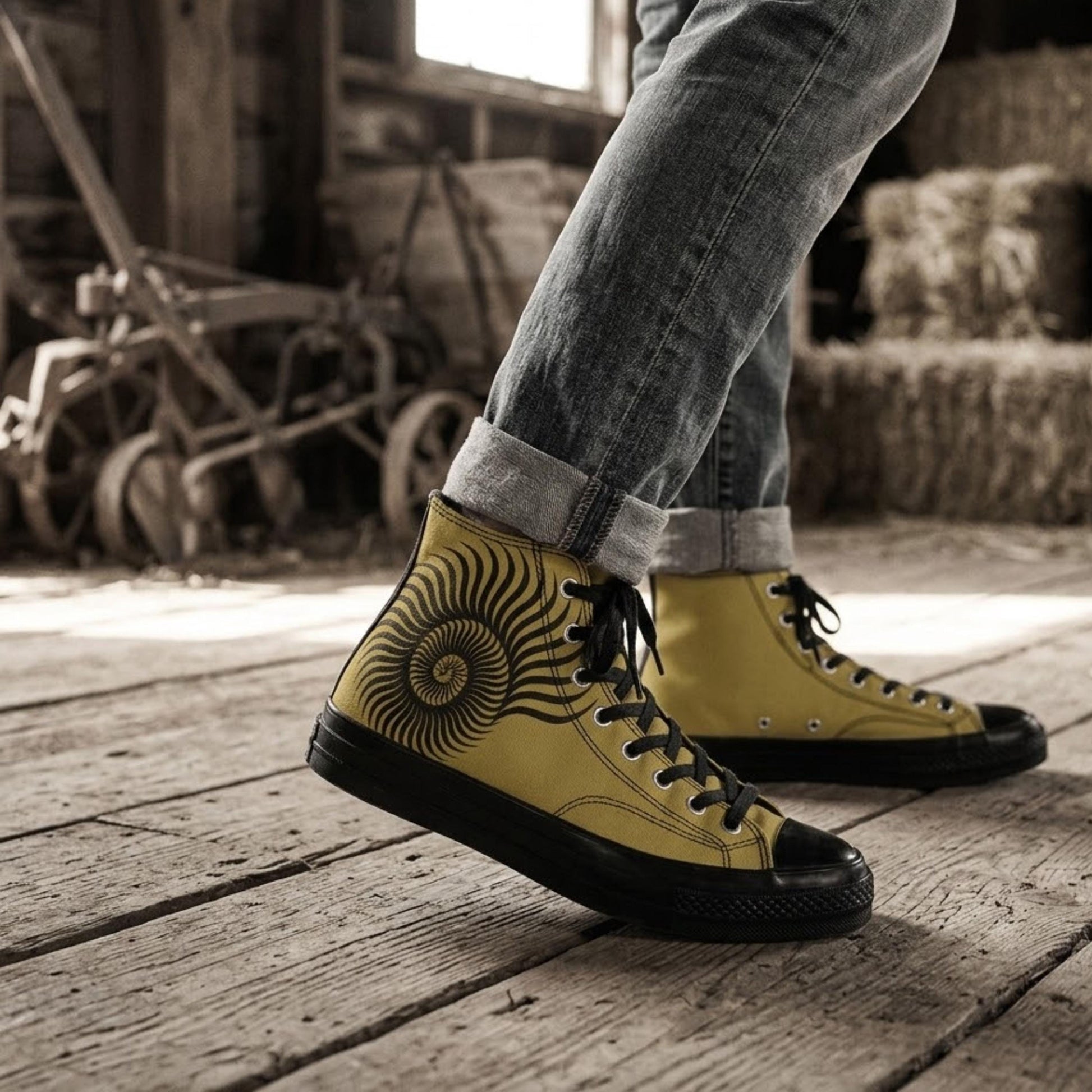 A person wearing yellow and black sneakers with a spiral design on the side, standing on a wooden floor in a rustic setting.
