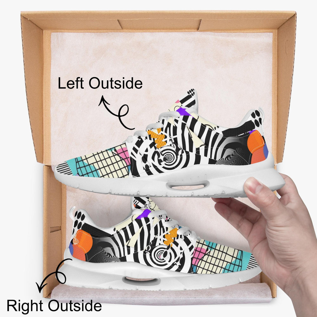 A hand is holding a pair of colorful, patterned sneakers with a box containing the shoes.