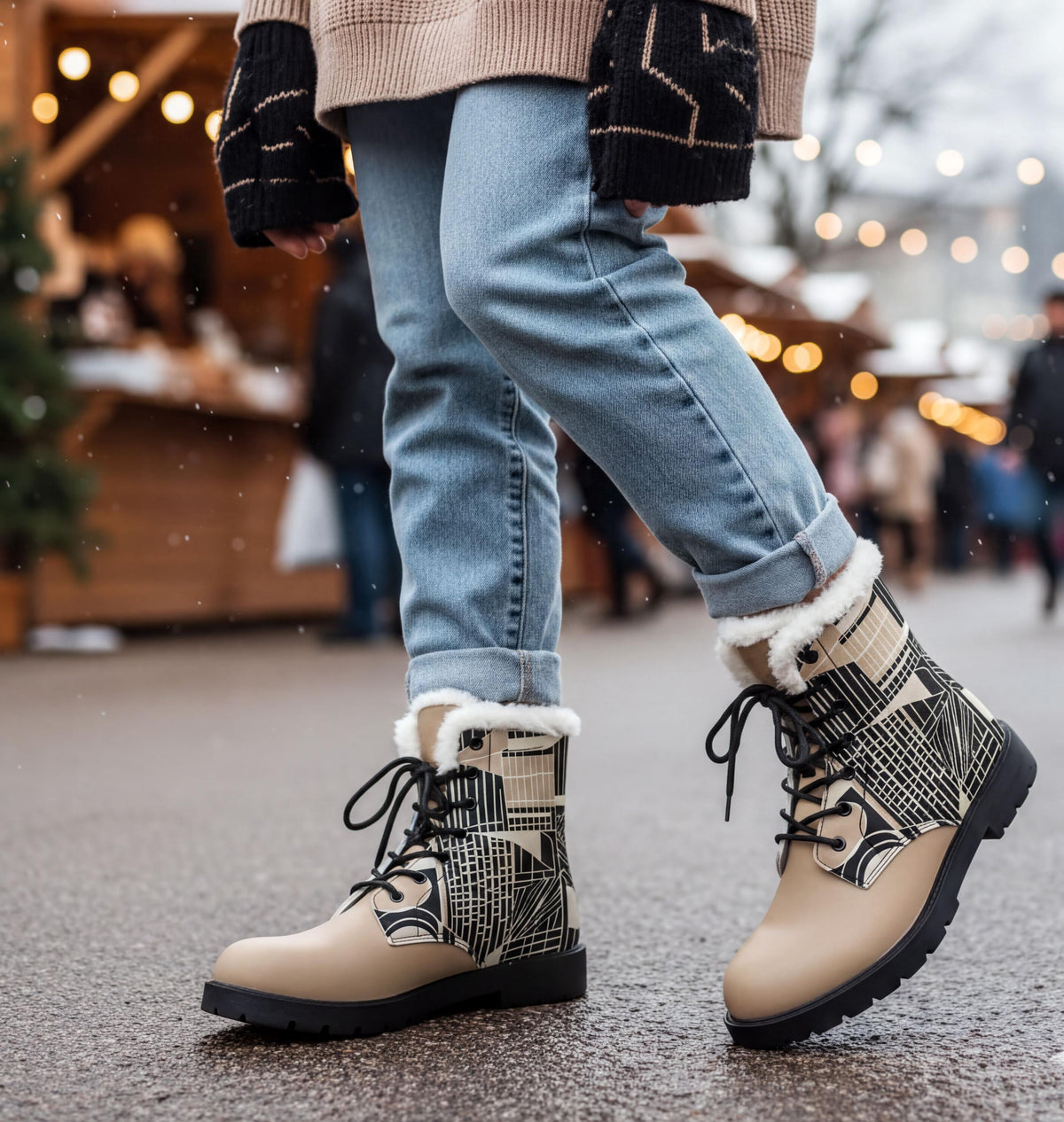 A person wearing a beige sweater, blue jeans, and patterned boots is walking on a street with a blurred background of people and lights.