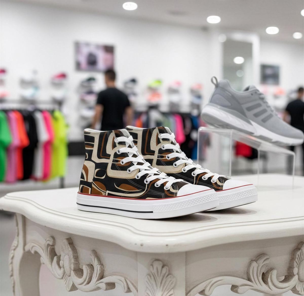 A pair of high-top sneakers with a black and white patterned design, displayed on a white table in a retail setting.