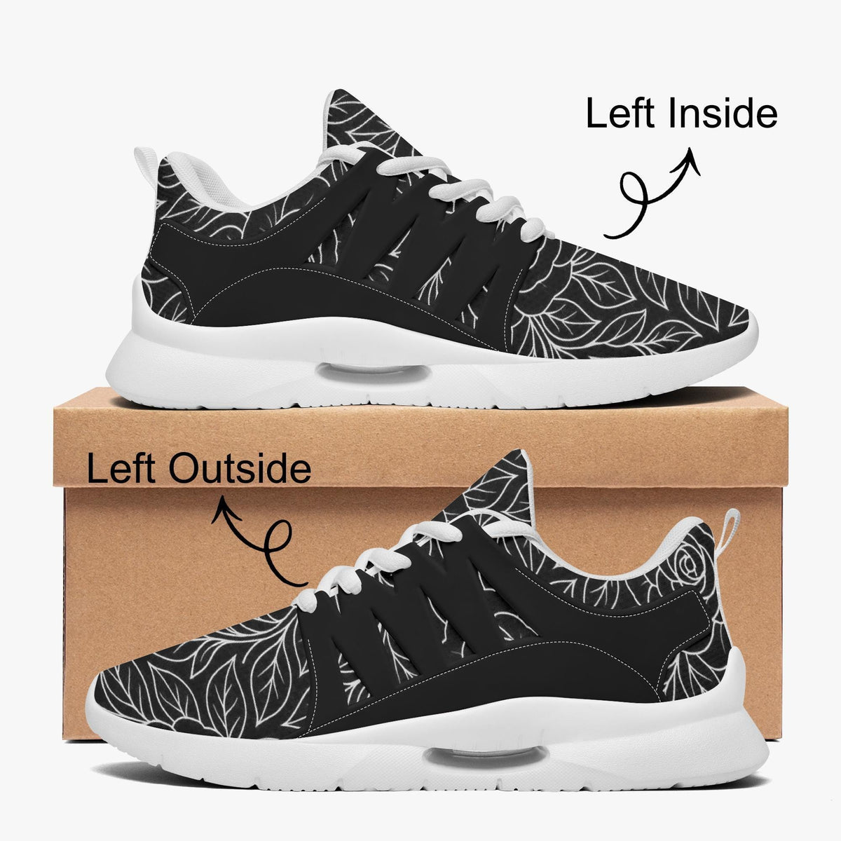 A pair of black and white sneakers with a leaf pattern, displayed on top of a cardboard box.