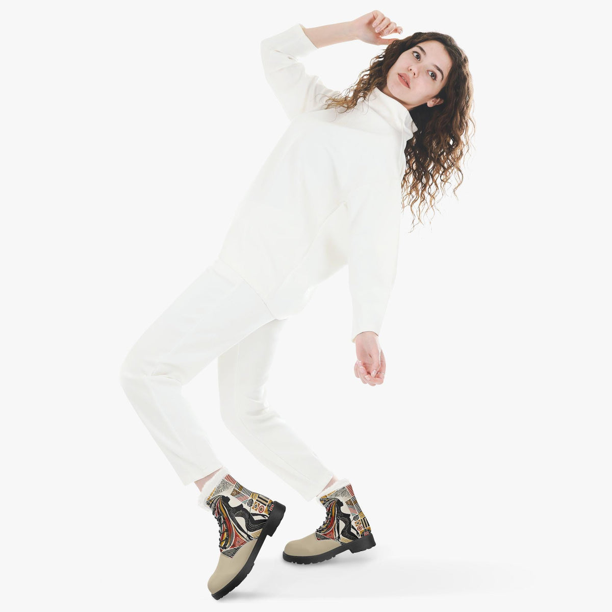 A woman in a white outfit and patterned boots is striking a dynamic pose with one hand on her head and the other on her hip.